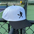 White and black cap with a tennis player silhouette on a tennis court background